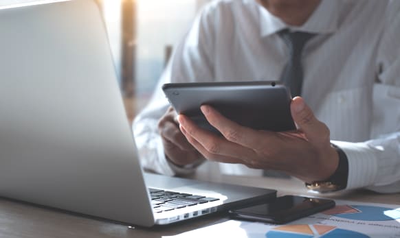 Superintendent checks data on tablet and computer