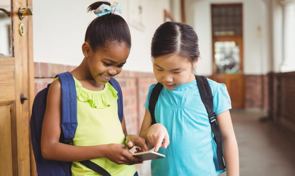 Two girls ordering school lunch from phone.