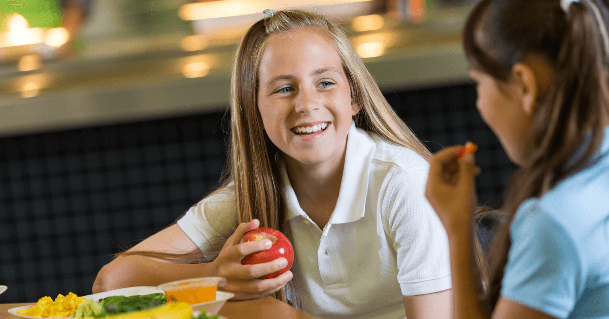 Student enjoying a healthy snack as defined by the Smart Snacks in Schools Standard