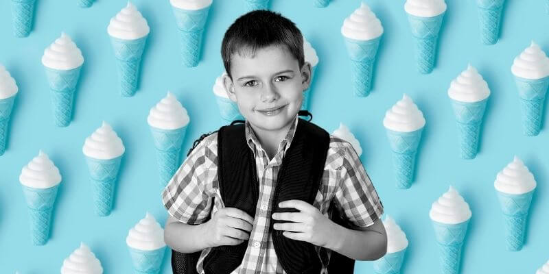 Caucasian boy with backpack on standing in front of blue background of ice cream cones repeating real-time syncing