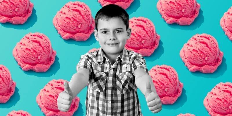 Caucasian boy giving thumbs up standing in front of blue background of ice cream scoops repeating real-time syncing