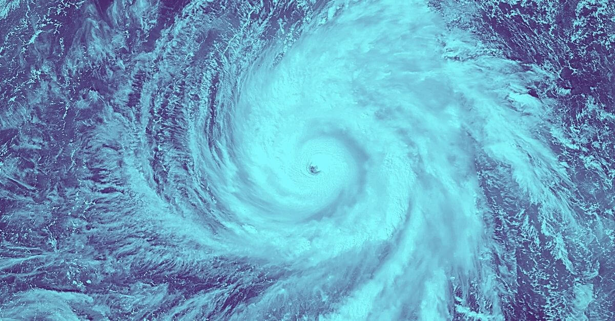 Dark and light blue image of a hurricane from space disaster planning for school districts