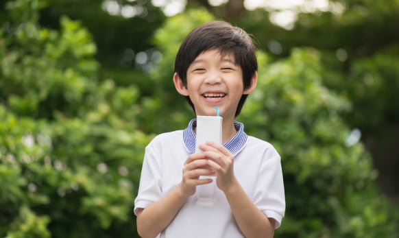 boy drinking from milk carton