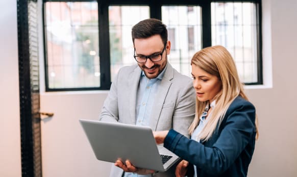 Two colleagues looking at computer