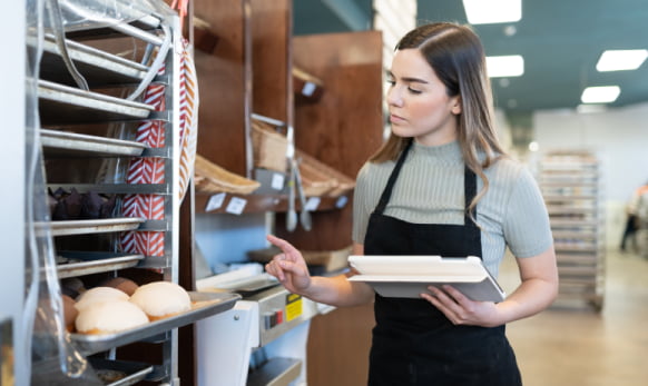 School lunchroom worker preparing food