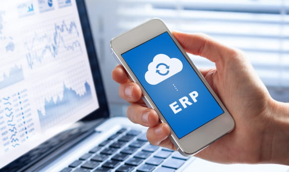 Holding a phone showing ERP going to the cloud