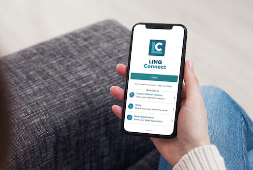 Parent holding phone looking at LINQ Connect app
