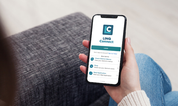 Parent holding phone looking at LINQ Connect app