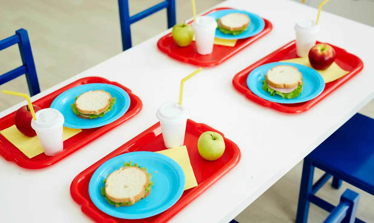 4 lunch trays at a table